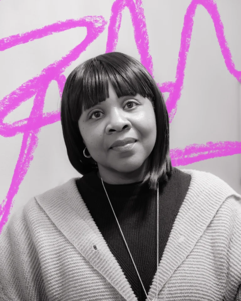 a close up black and white portrait of a woman with a dark bob haircut. Behind her is a hand-drawn scribble in neon pink.